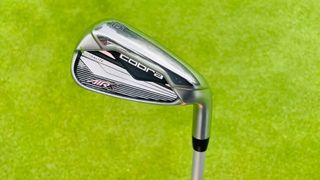 The Cobra Air X Women’s Iron's held aloft on the golf course