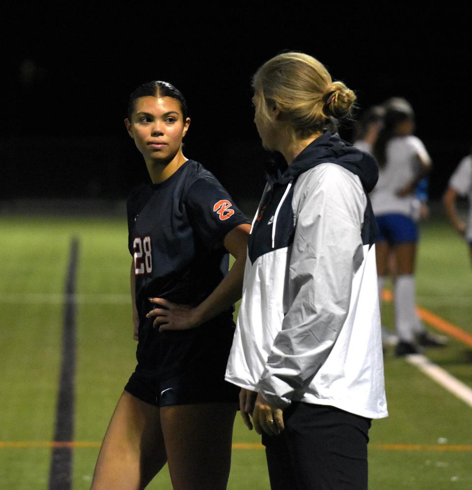 Benjamin's Sam Woods game-plans with coach Hillary Carney during a water break in the second half of the Bucs' district playoff game against Cardinal Newman on Jan. 27, 2025.