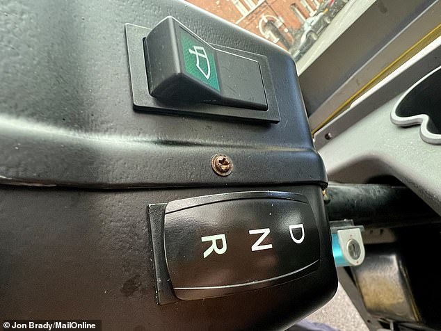 The other side of the steering column features a gear selector and a windscreen wiper switch