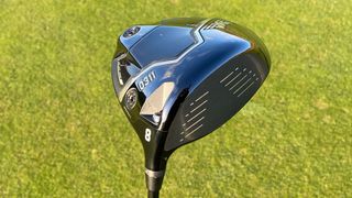 The sole and face of the PXG Black Ops driver with grass background