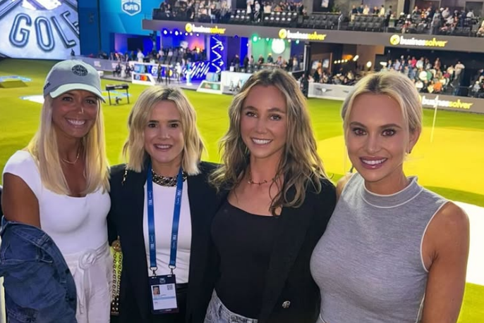 Four women at a golf event.