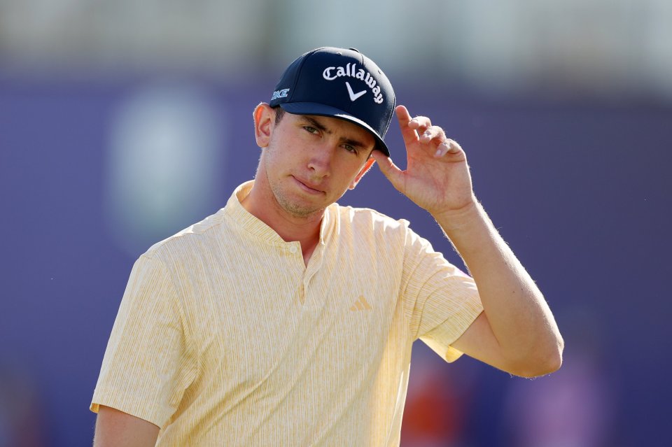 a man wearing a yellow shirt and a callaway hat