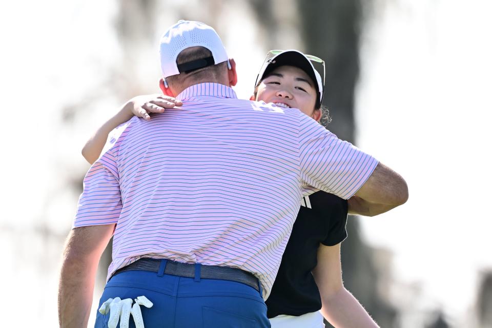 Rose Zhang of the United States and John Smoltz embrace on the 18th green during the first round of the Hilton Grand Vacations Tournament of Champions 2025 at Lake Nona Golf & Country Club on January 30, 2025 in Orlando, Florida.