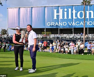 A Lim Kim is presented with the Tournament of Champions trophy by HGV CEO Mark Wang