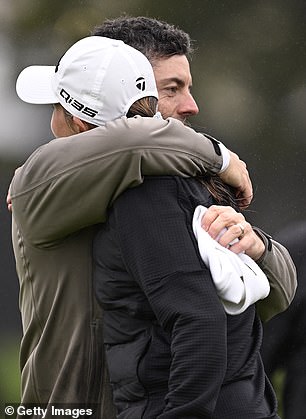 The pair shared an embrace on the 9th green at the end of their round