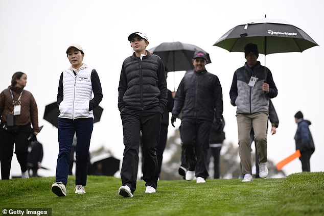 Trump walks down the fairway during her star-studded round with the former world No 1