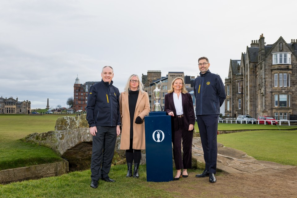 ST ANDREWS, SCOTLAND - JANUARY 23: Richard Lochhead (Business Minister, Scottish Government), Sandra Tuddenham (Chair of St Andrews Links Trust), Rhona Corscadden (Head of Sport Delivery, VisitScotland) and Mark Darbon (Chief Executive of The R&A) pose with the Claret Jug as they announce that the Old Course St Andrews will be the venue for The 155th Open in 2027, at St Andrews Old Course on January 23, 2025 in St Andrews, Scotland. (Photo by Raymond Davies/R&A/R&A via Getty Images)