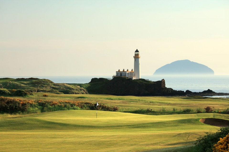 Lighthouse on a golf course overlooking the ocean.