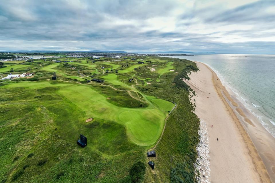 Aerial view of a golf course next to a beach.