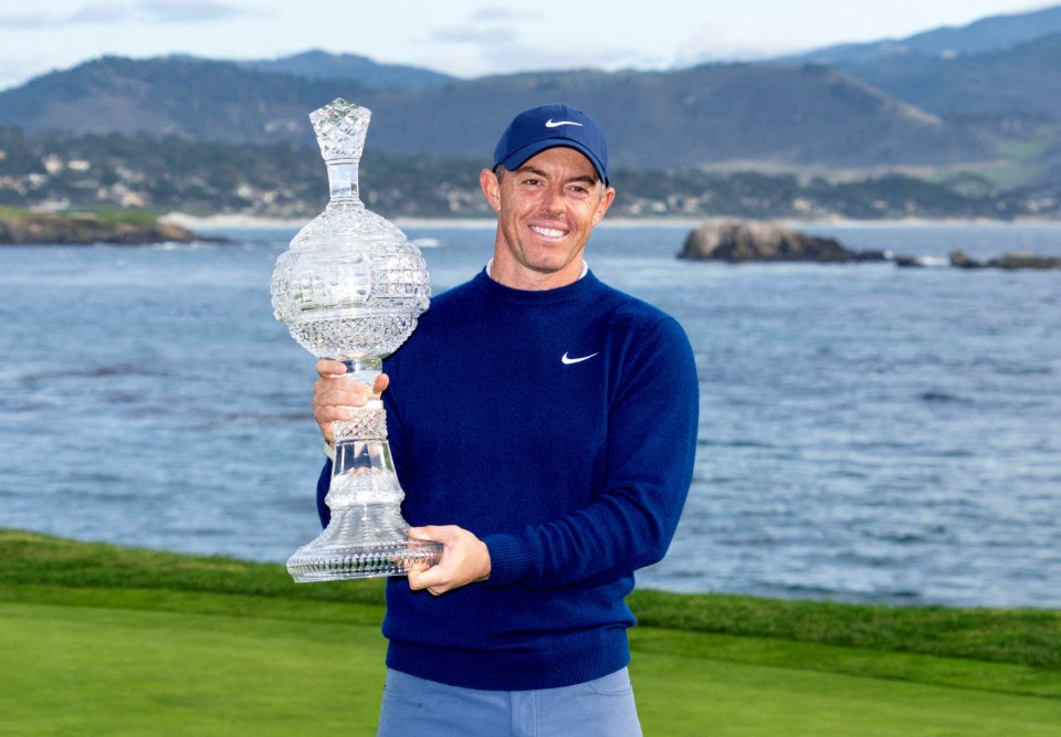Rory McIlroy holding the AT&T Pebble Beach Pro-Am trophy.