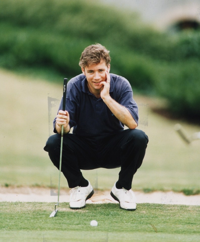 Ally McCoist on a golf course, crouching with a putter.