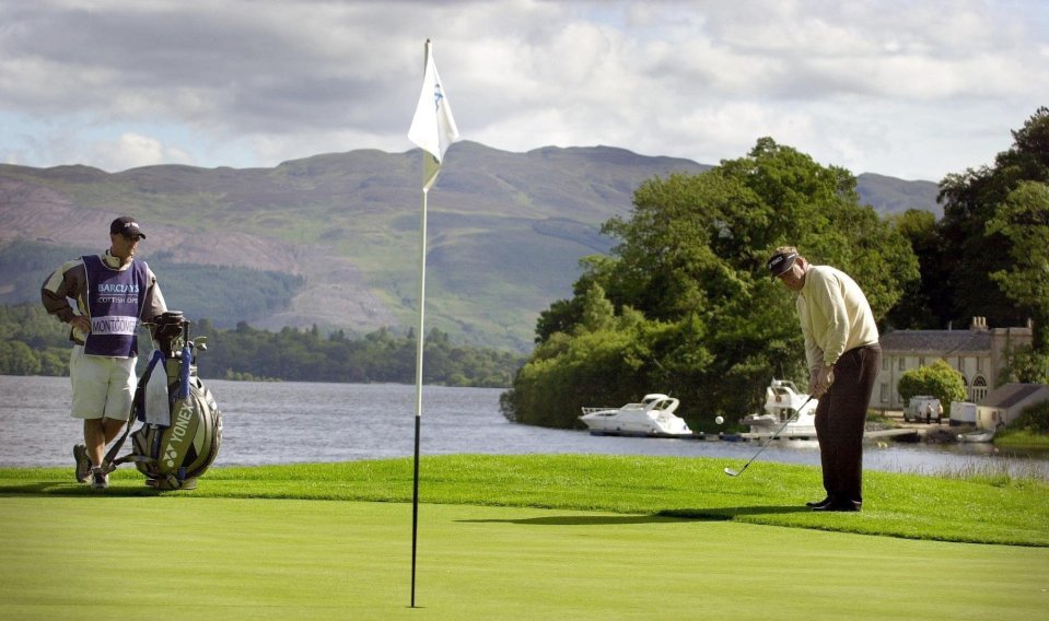 Colin Montgomerie and his father walking on a golf course.