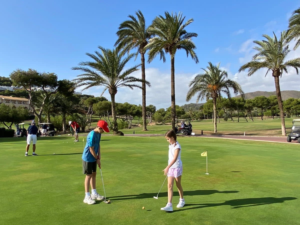 Serious players mingle with young novices on the practice greens (Caroline Gammell)