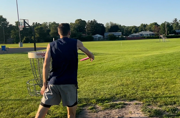 Jonathan, from behind, throwing a shot