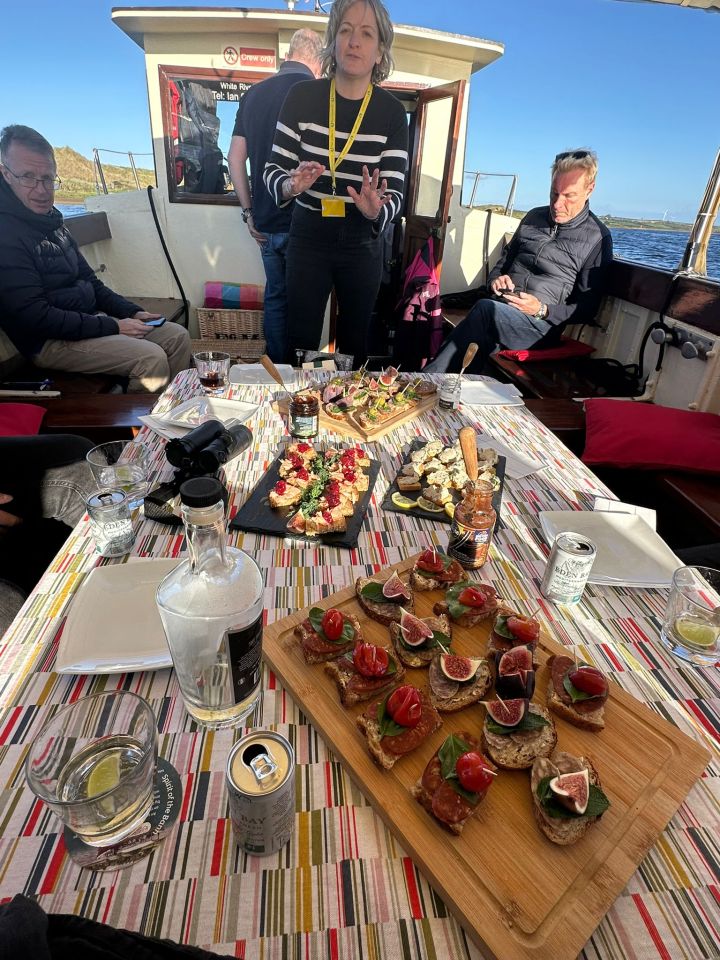 Appetizers and drinks on a table on a boat.