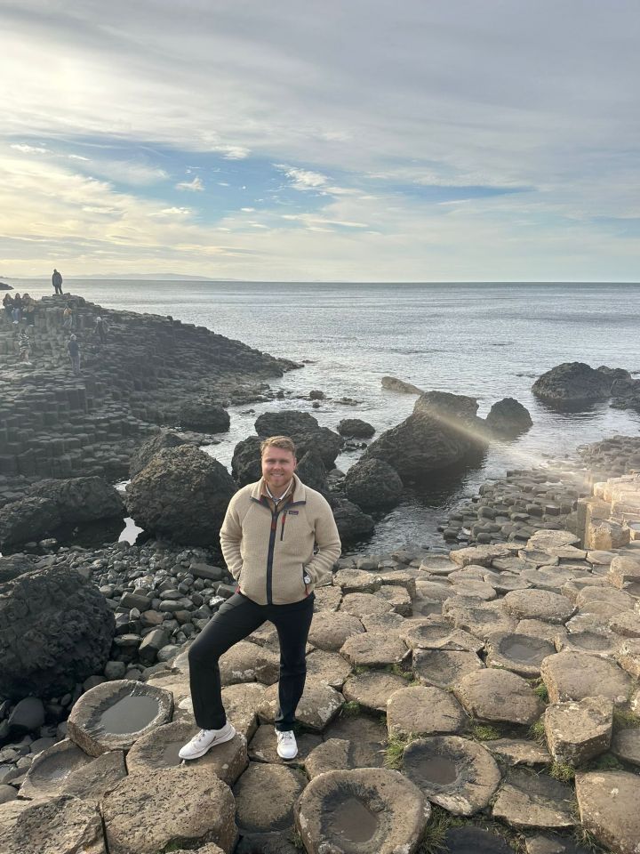 Man standing on Giant's Causeway in Northern Ireland.