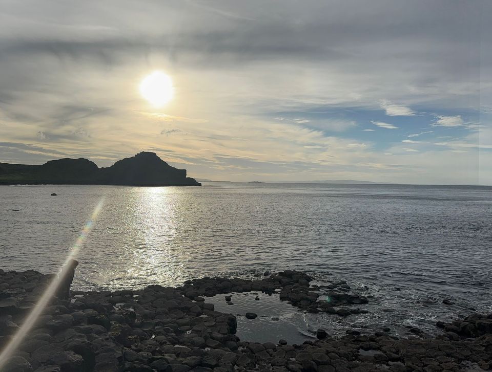 Sunset over rocky coastline in Northern Ireland.