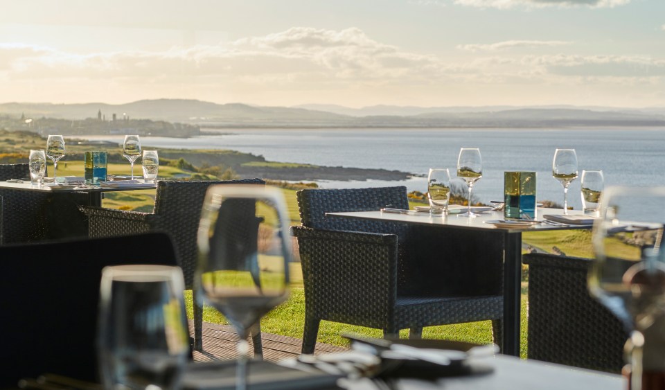 Outdoor patio dining overlooking a bay.