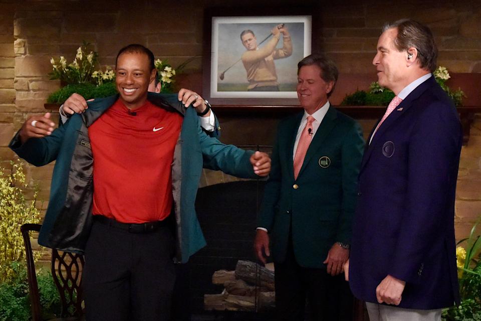 Tiger Woods receives the green jacket from Patrick Reed in Butler Cabin as Augusta National chairman Fred Ridley and CBS announcer Jim Nantz look on at the Masters. (Rusty Jarrett/Augusta National/Handout Photo via USA TODAY Sports)
