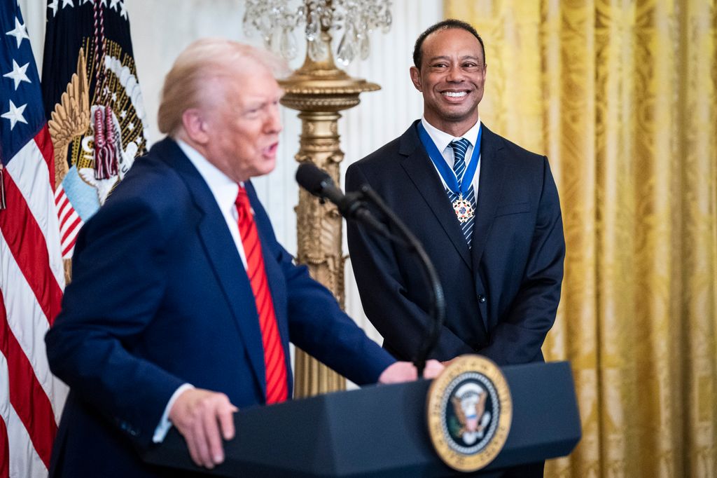 President Donald J Trump speaks with Tiger Woods during a reception honoring Black History Month in the East Room at the White House