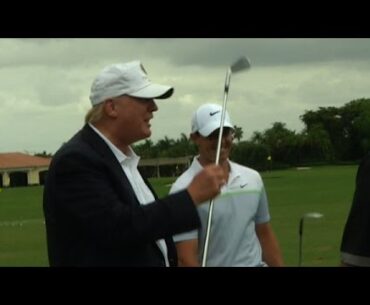 Donald Trump returns the 3-iron to Rory McIlroy at Cadillac Championship