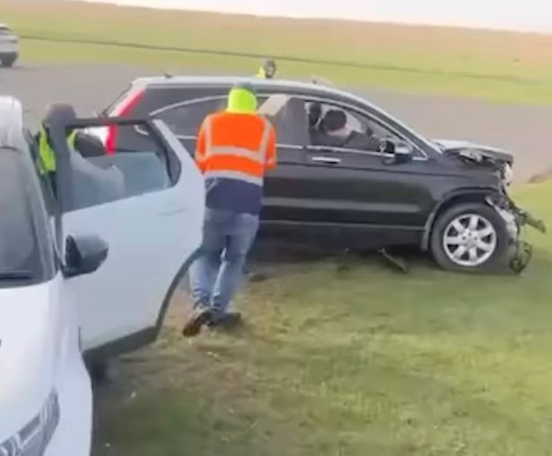 A man in a hi viz jacket attacks a van