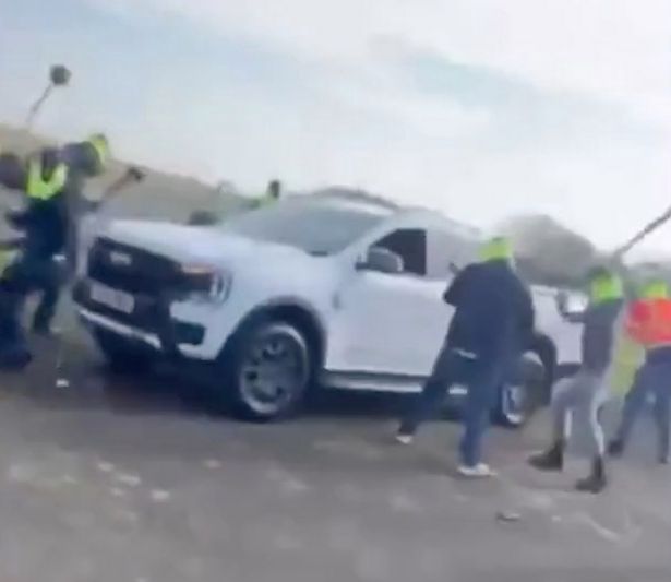 a number of masked men descended on a traveller encampment and attacked people and vehicles with shovels and golf clubs