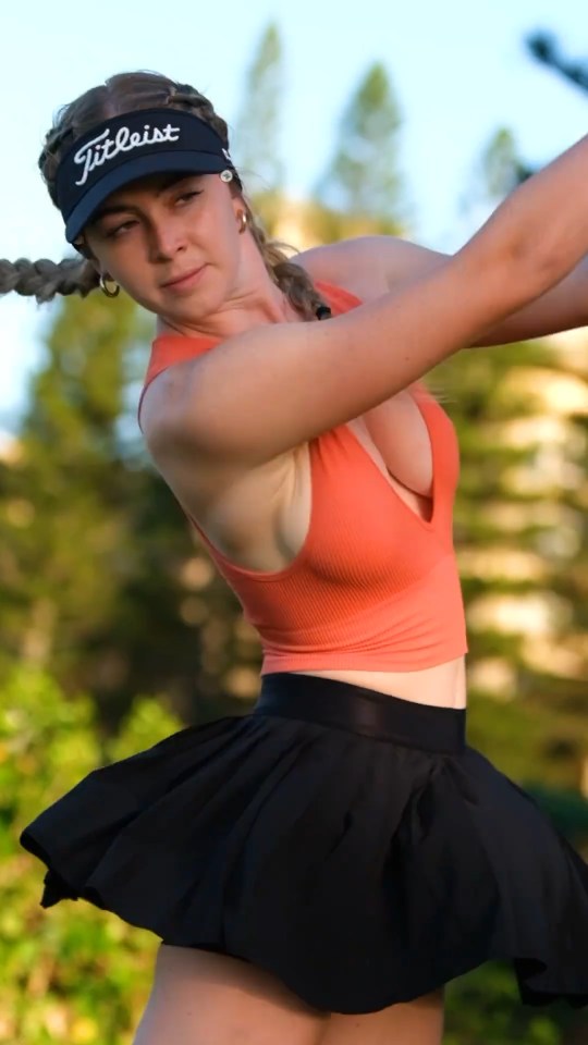 Grace Charis golfing in a daring outfit.