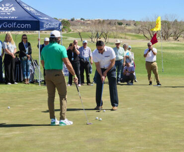 Lt. Gov. Howie Morales gets a putting lesson from celebrity pro Manolo Vega.