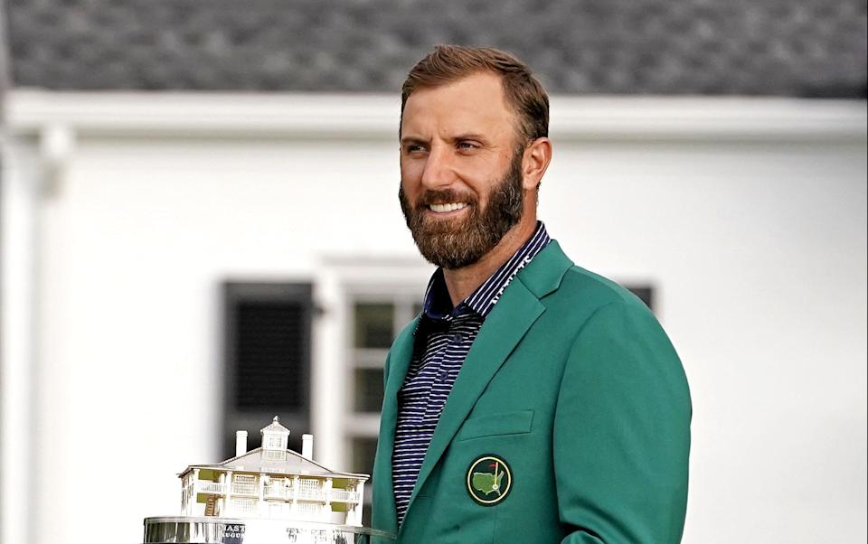 Dustin Johnson celebrates with the Masters Trophy after winning The Masters golf tournament at Augusta National GC.