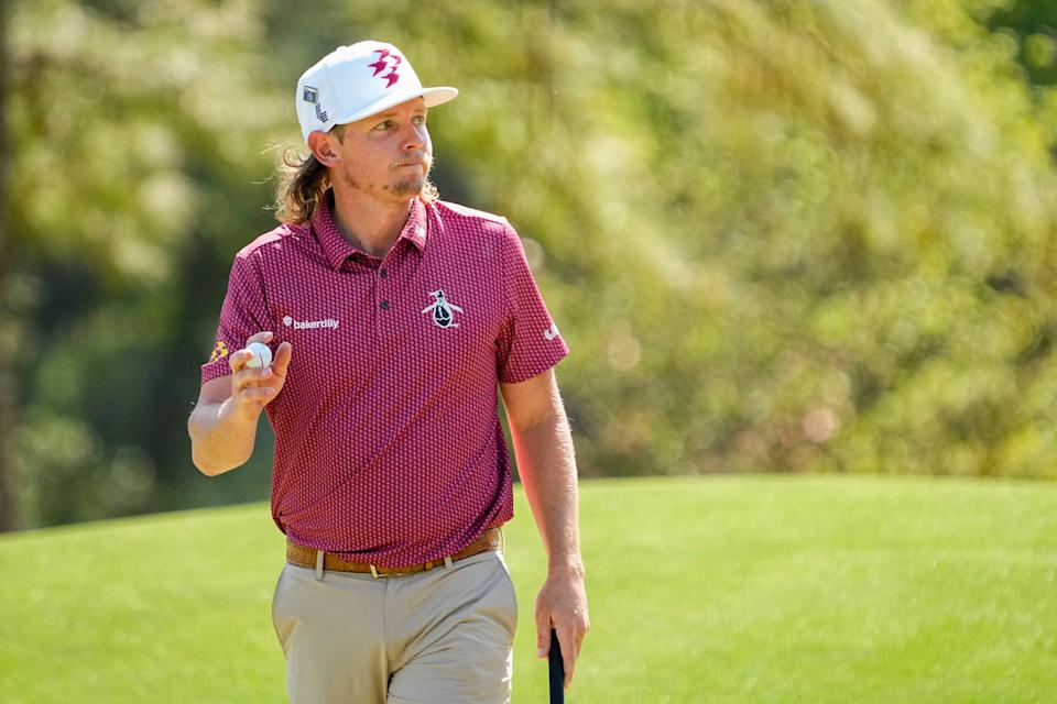 Cameron Smith waves to patrons after putting for par on No. 8 during the final round of the Masters Tournament.