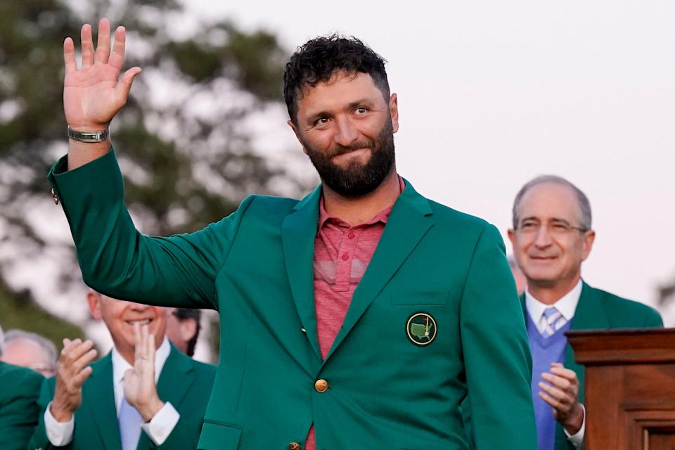 Jon Rahm is presented with the green jacket after winning the 2023 Masters.