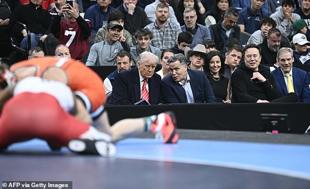 Trump then took his seat in a VIP section by the mat alongside Senator Dave McCormick