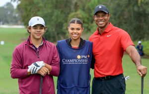 ORLANDO, FLORIDA - DECEMBER 17: Tiger Woods of The United States poses for a picture on the first tee with his son Charlie Woods and his daughter Sam Woods who was caddying for Tiger during the final round of the PNC Championship at The Ritz-Carlton Golf Club on December 17, 2023 in Orlando, Florida. (Photo by David Cannon/Getty Images)