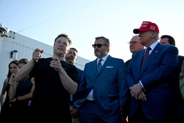 BROWNSVILLE, TEXAS - NOVEMBER 19: Elon Musk speaks with U.S. President-elect Donald Trump (R) and guests including Donald Trump Jr. (2nd from left), Sen. Ted Cruz (R-TX) (C) and Kevin Cramer (R-ND) at a viewing of the launch of the sixth test flight of the SpaceX Starship rocket on November 19, 2024 in Brownsville, Texas. SpaceX's billionaire owner, Elon Musk, a Trump confidante, has been tapped to lead the new Department of Government Efficiency alongside former presidential candidate Vivek Ramaswamy. (Photo by Brandon Bell/Getty Images)