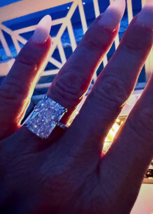 Close-up of a hand wearing a large diamond ring.