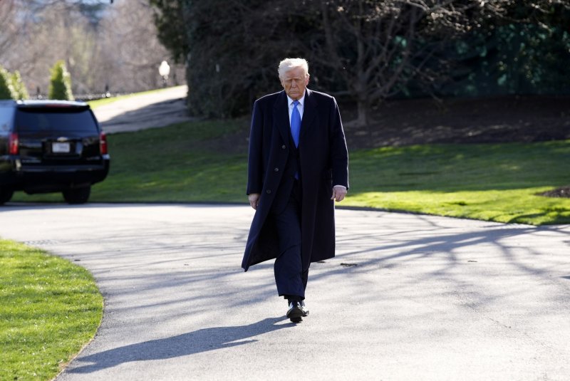 President Donald Trump walks over to speak to reporters as he leaves the White House en route to New Jersey on Friday. Photo by Yuri Gripas/UPI