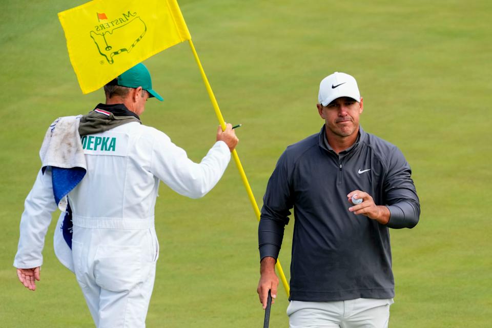Brooks Koepka walks off the 15th green after making his par putt during the third round of The Masters golf tournament.