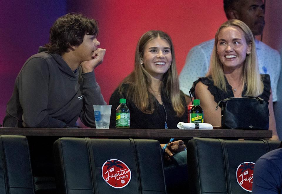 Charlie Woods talks to Kai Trump, center, and her mom Vanessa Trump at a TGL match between Jupiter Links GC and Atlanta Drive GC at SoFi Center on March 4, 2025, in Palm Beach Gardens, Florida.