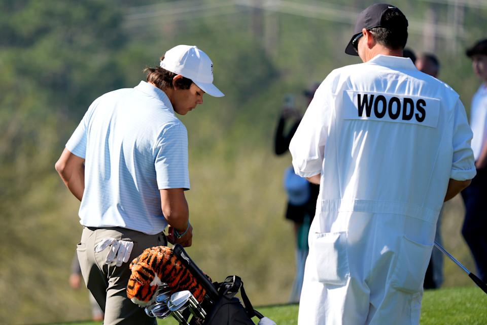 Mar 19, 2025; Graniteville, South Carolina, USA; Charlie Woods stands with his caddie in the practice area before the first round of the Junior Invitational at Sage Valley Golf Club. Woods is the son of golf legend Tiger Woods and finished at +6. Mandatory Credit: Katie Goodale - Augusta Chronicle/USA TODAY NETWORK