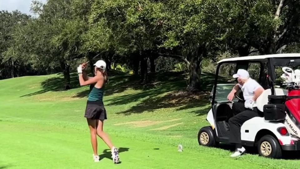 President Donald Trump watches on as his granddaughter Kai takes a swing. (Kai Trump)