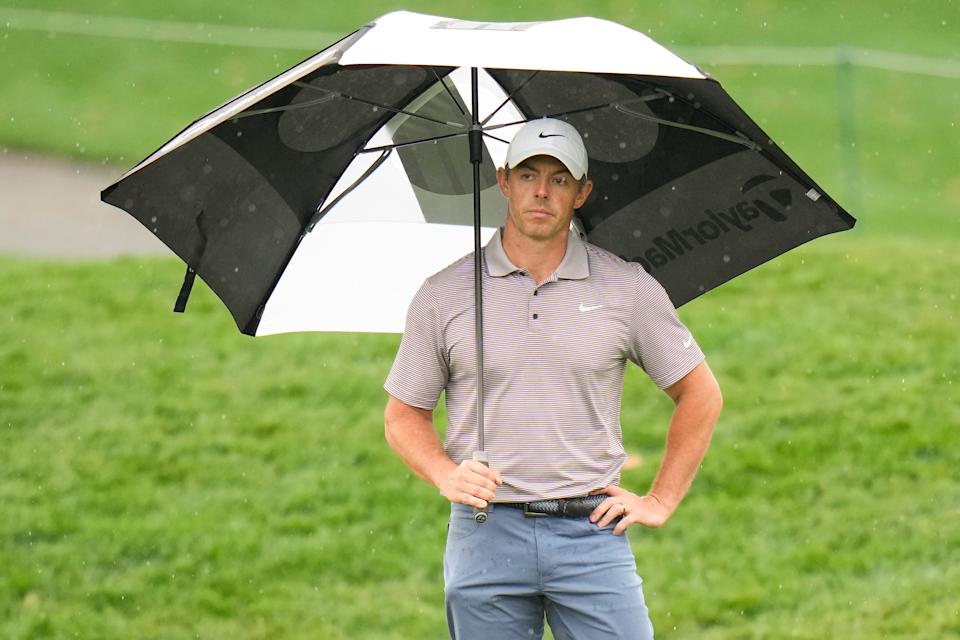 Rory McIlroy, of Northern Ireland, holds an umbrella on the 11th green during the final round of The Players Championship golf tournament Sunday, March 16, 2025, in Ponte Vedra Beach, Fla. (AP Photo/Chris O'Meara)