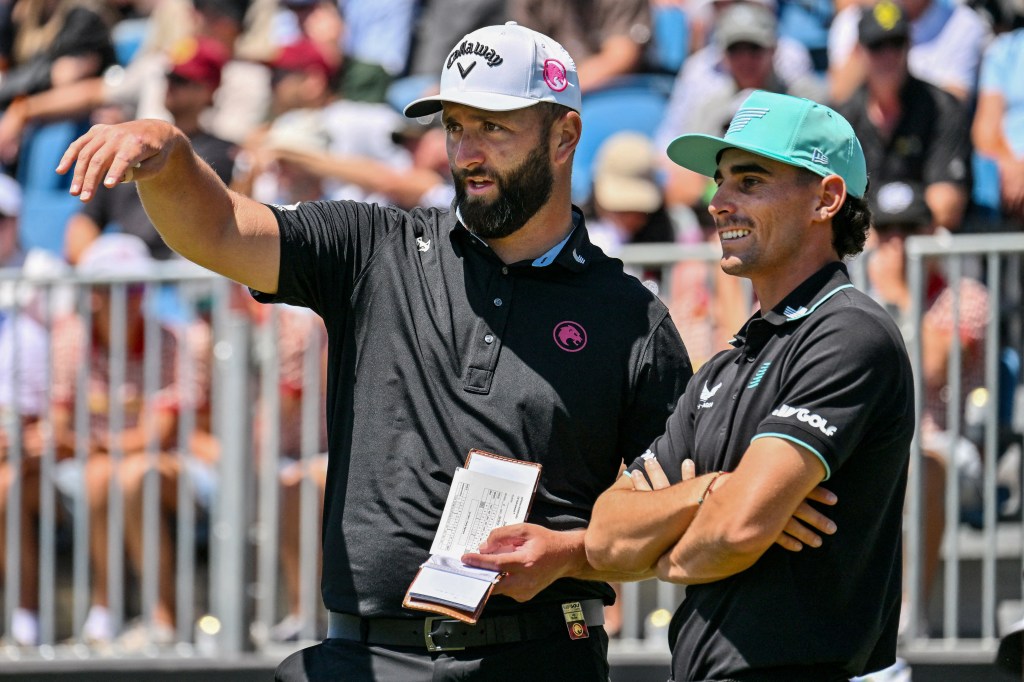 Spain's Jon Rahm (L) talks to Chile's Joaquin Niemann during the final day of the LIV Golf Adelaide at the Grange Golf Club in Adelaide on February 16, 2025. 