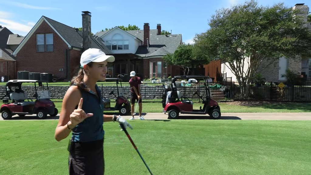 Kai Trump golfing in her video.