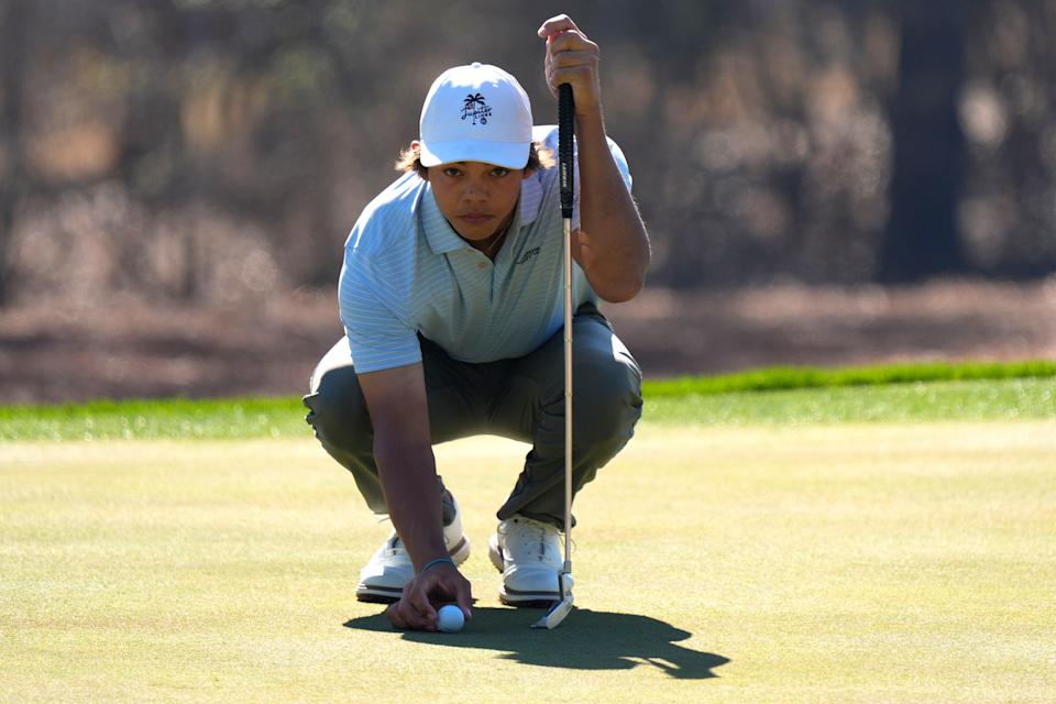 Mar 19, 2025; Graniteville, South Carolina, USA; Charlie Woods lines up his ball on No. one green during the first round of the Junior Invitational at Sage Valley Golf Club. Woods is the son of golf legend Tiger Woods and finished at +6. Mandatory Credit: Katie Goodale - Augusta Chronicle/USA TODAY NETWORK