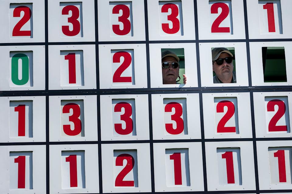 Leaderboard operators on the seventh hole during the final round of the 2024 Masters Tournament at Augusta National Golf Club.