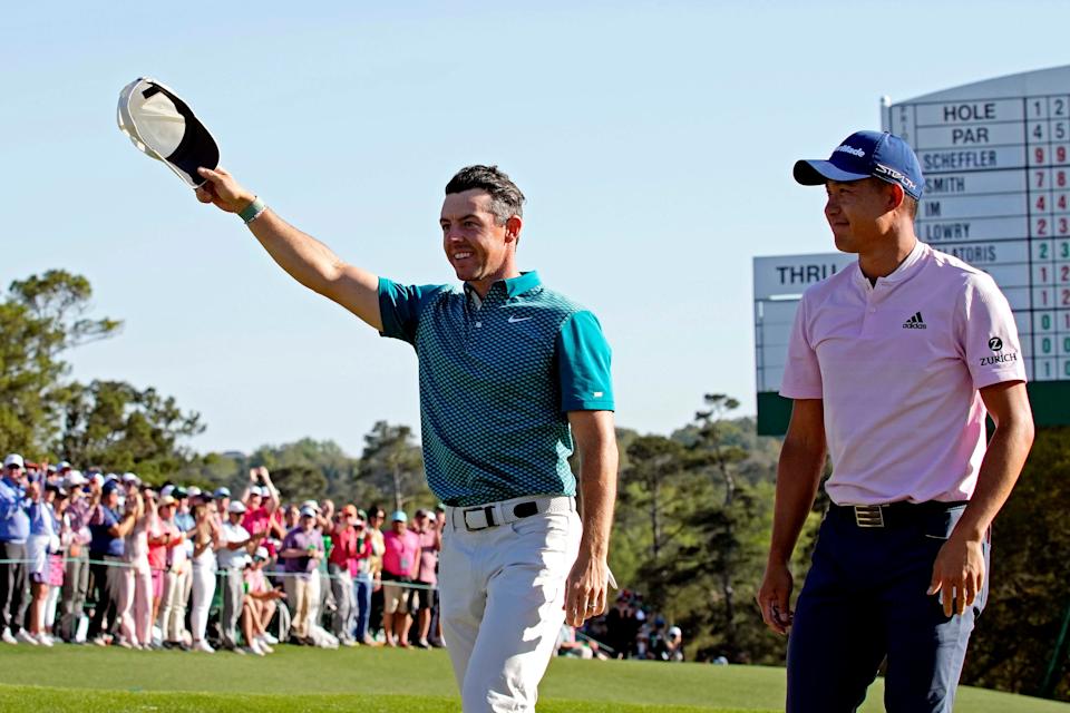 Rory McIlroy and Collin Morikawa celebrate after they each holed out from the same bunker on consecutive shots during the final round of the 2022 Masters Tournament. (Photo: Michael Madrid-USA TODAY Sports)