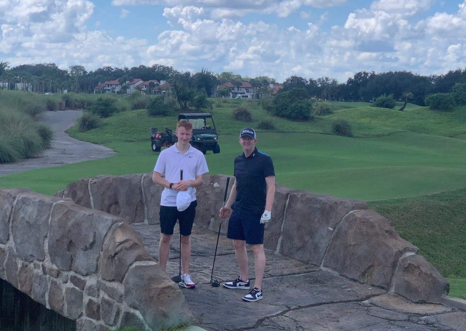 Two men on a golf course bridge.