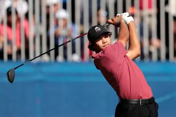 Charlie Woods takes a tee shot