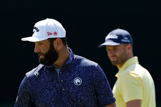 Jon Rahm of Spain walks past Wyndham Clark on the fifth green during the first round of the 2025 Masters Tournament